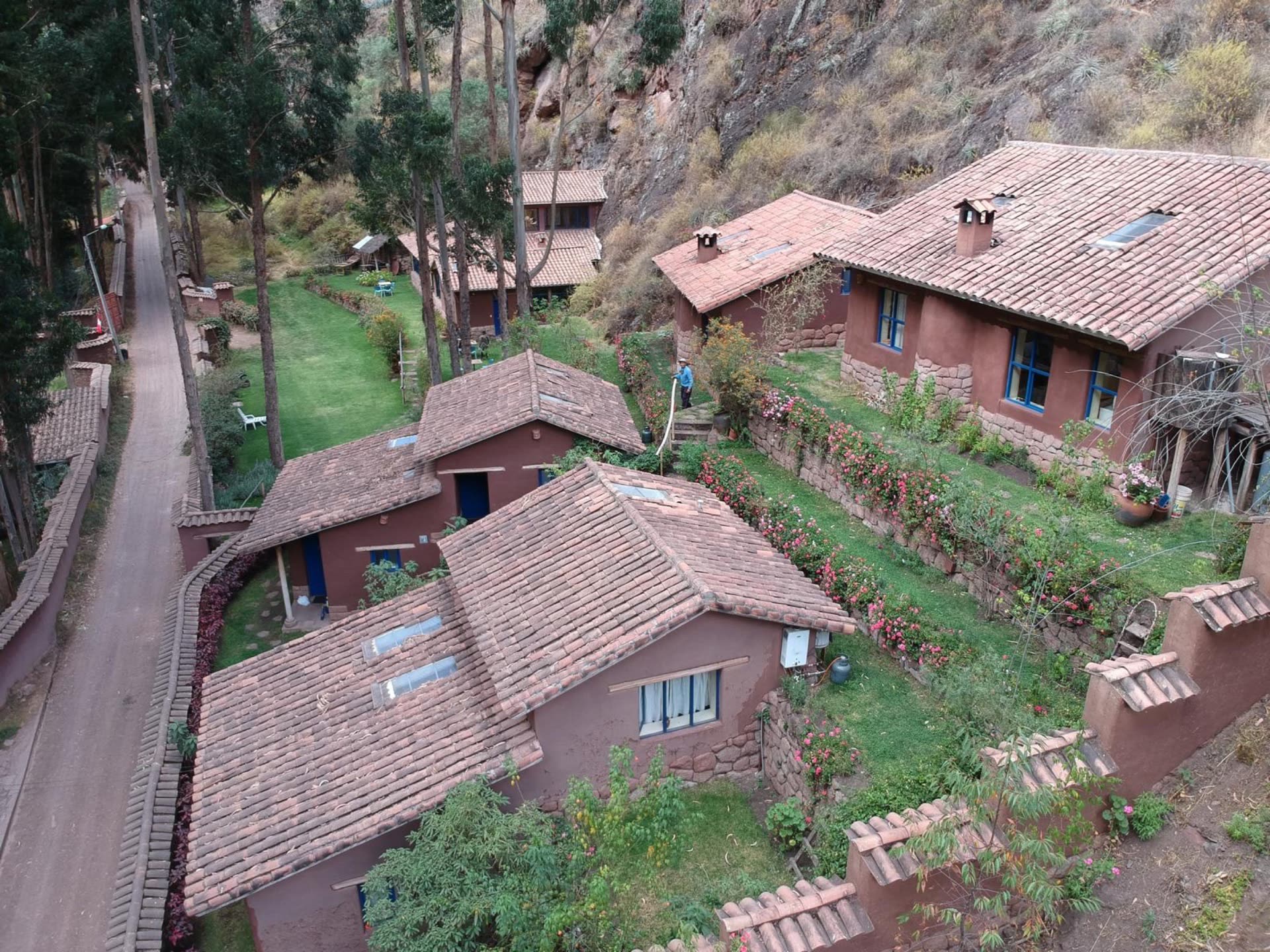 Aerial view of the WAKAN retreat casitas on the hillside, gardens and cliff face behind.