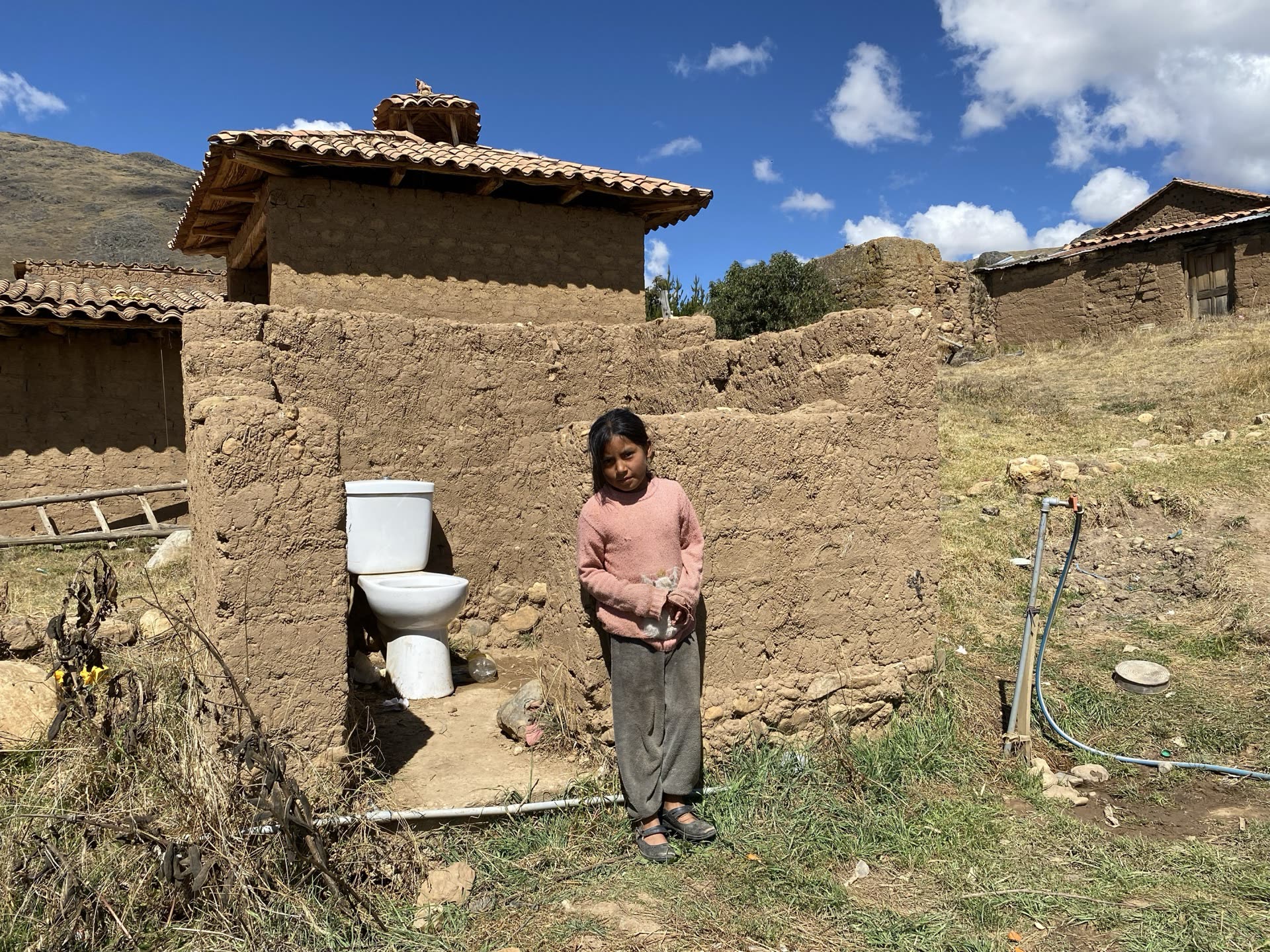 Clean water running into a basin beside a family home in the Sacred Valley.